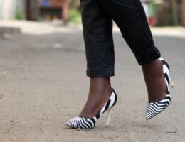 a woman wearing a black and white striped high heels