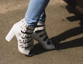 person showing pair of white peep toe chunky heel sandals