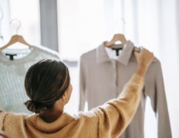 Anonymous woman choosing clothes in store