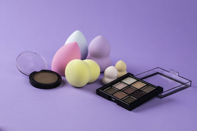 Makeup Products on Purple Surface