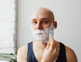 Bald Man Applying Shaving Cream on His Face
