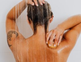 Woman Under Shower Washing Her Back