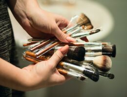 Person Holding Makeup Brushes