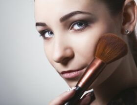 A Woman Holding a Makeup Bruch